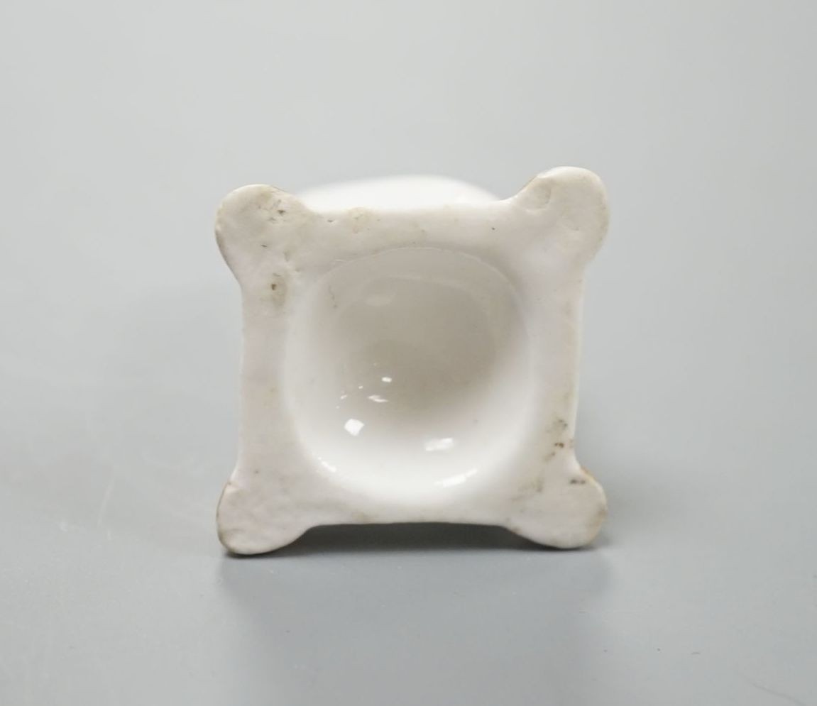A rare English porcelain model of a cat seated on a cushion base, possibly Derby, c.1820-30, 4cm high, Provenance: Dennis G.Rice collection